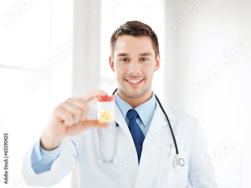 male doctor with jar of capsules