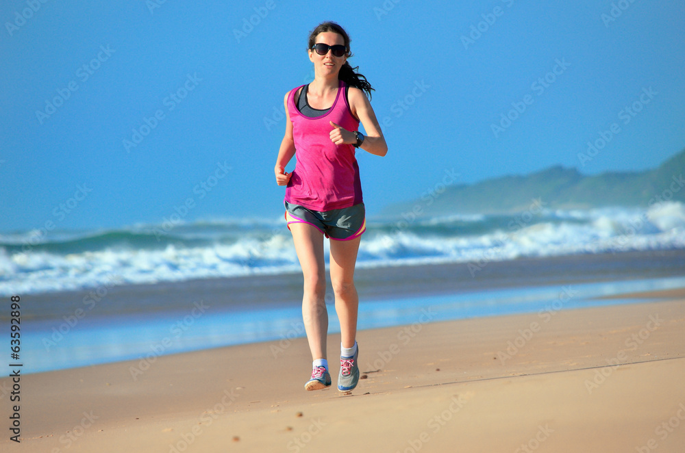 Woman running on beach, beautiful girl runner jogging outdoors Woman running on beach, beautiful girl runner jogging outdoors
