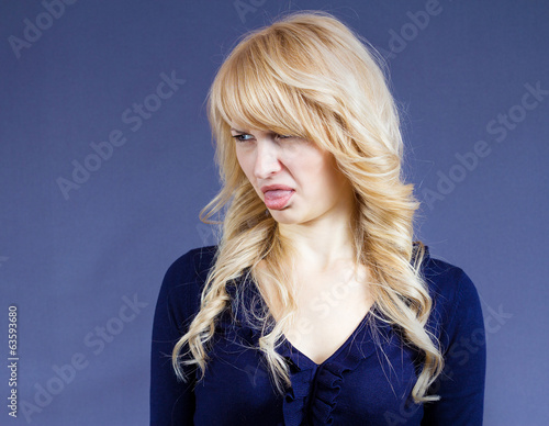 Foto Disgusted woman with bad taste in mouth