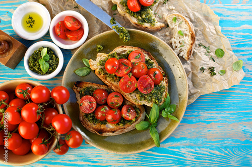 Bruschetta with fresh cherry tomatoes and herb pesto photo