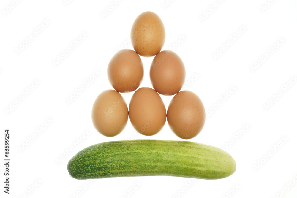 Egg put as triangle and cucumber isolated Egg put as triangle and cucumber isolated
