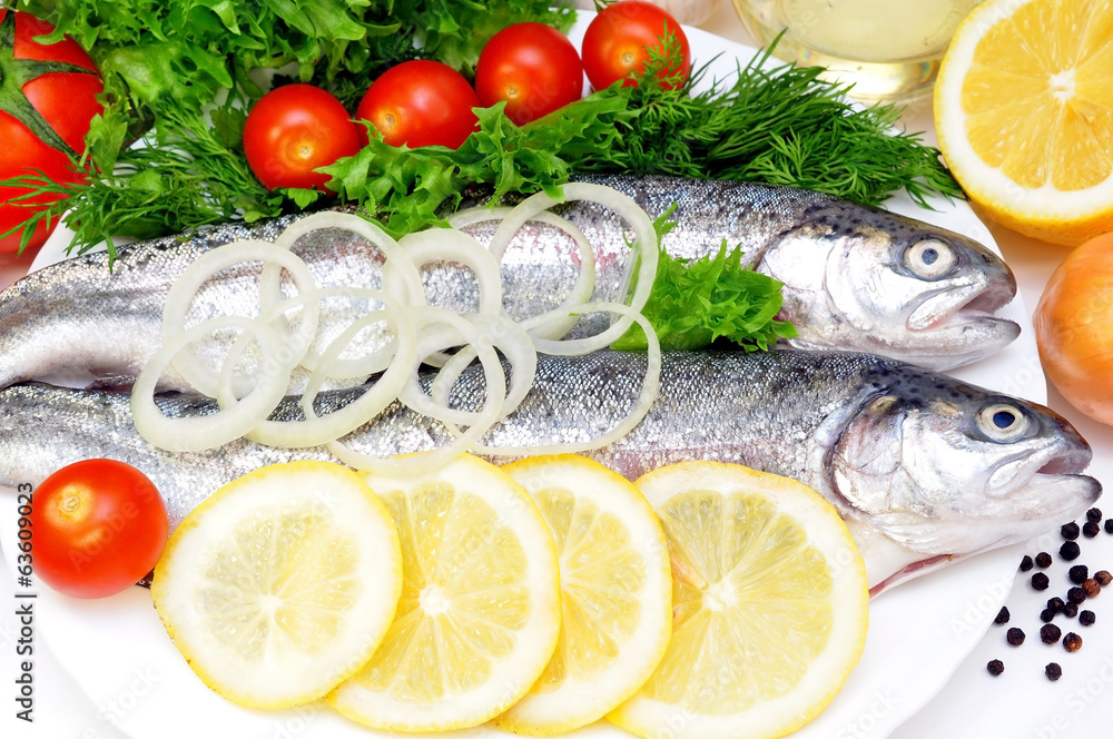 two rainbow trout with lemon and fresh vegetables two rainbow trout with lemon and fresh vegetables