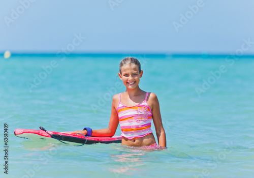 Cute girl with surfboard