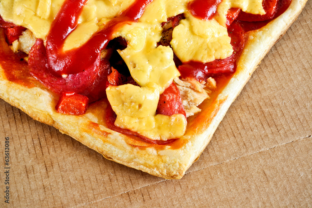 Tasty pizza with cheese, tomatoes and meat in a box Tasty pizza with cheese, tomatoes and meat in a box