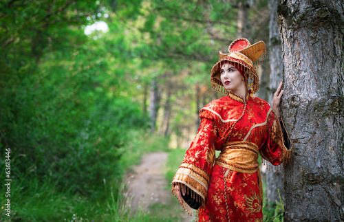 Woman in Chinese princess costume in the pine forest
