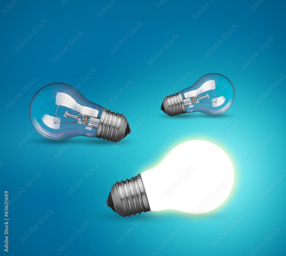 idea concept with glowing light bulb on blue background idea concept with glowing light bulb on blue background
