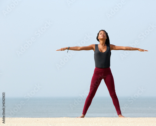 Fototapeta Naklejka Na Ścianę i Meble -  Woman yoga stretching at the beach