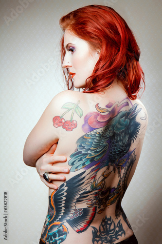 Portrait if young beautiful sexy tattooed woman with stylish mak
