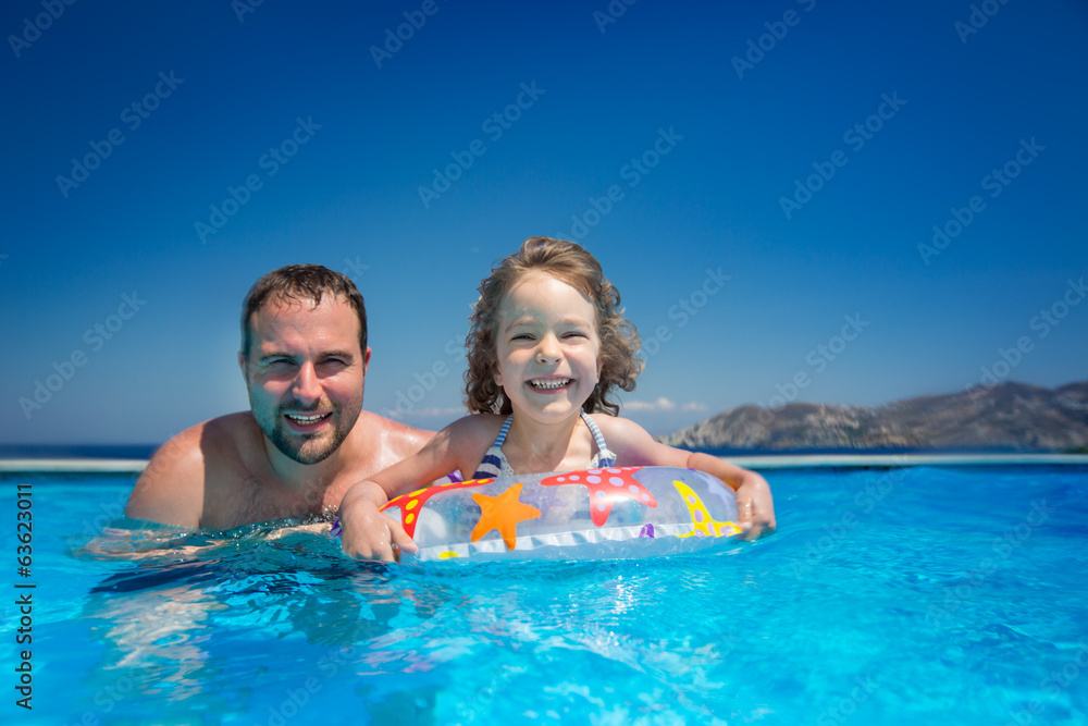 Child with father in swimming pool Child with father in swimming pool