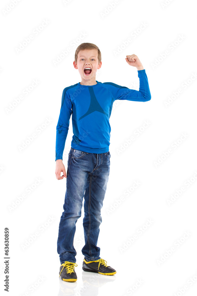 Naklejka premium Shouting young boy with arm raised.