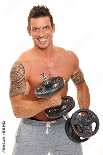 Handsome man exercises with dumbbells biceps and poses