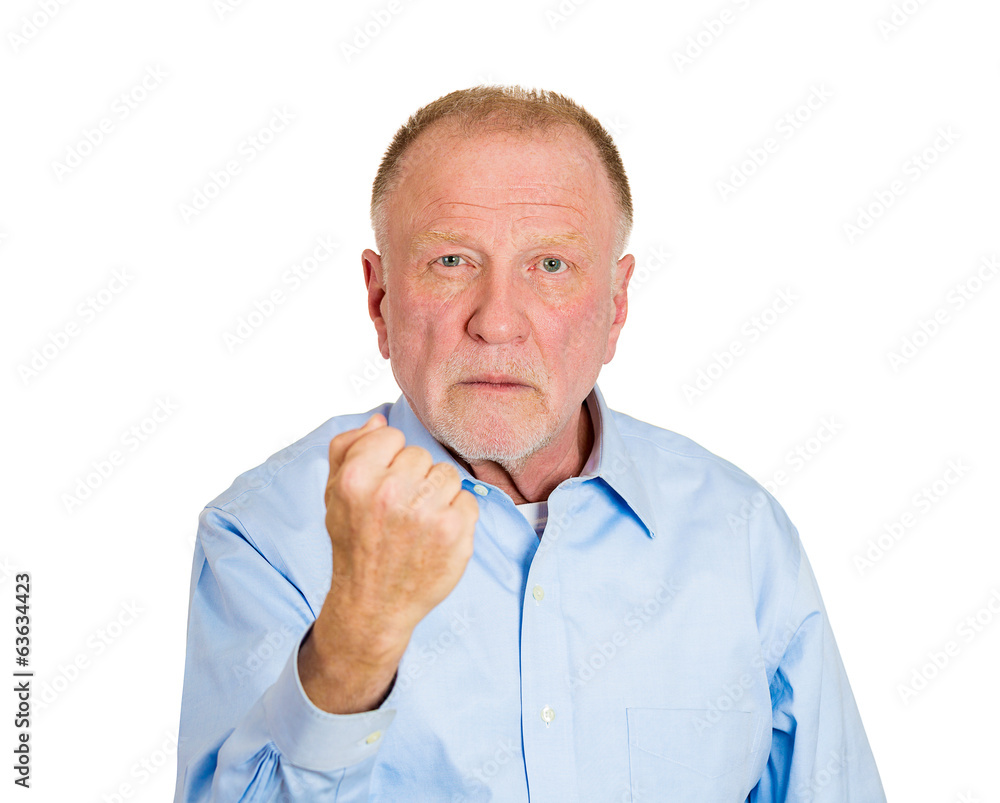 Knuckle sandwich. Older angry man with fist up in air Knuckle sandwich. Older angry man with fist up in air
