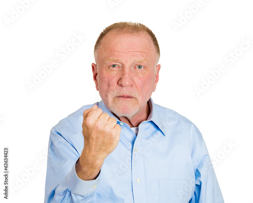 Knuckle sandwich. Older angry man with fist up in air © pathdoc