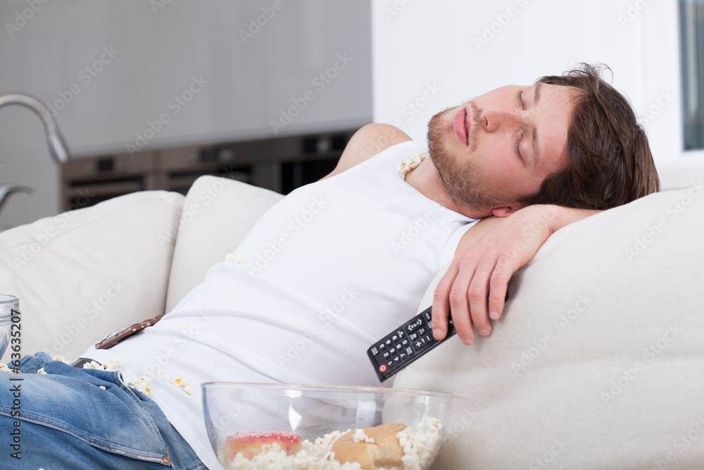 Foto Tired man sleeping on couch