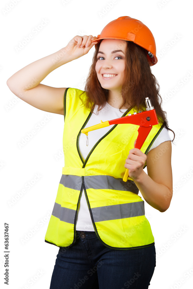 Young woman builder in vest and a helmet with a tool in his hands. Isolated on white background. Young woman builder in vest and a helmet with a tool in his hands. Isolated on white background.
