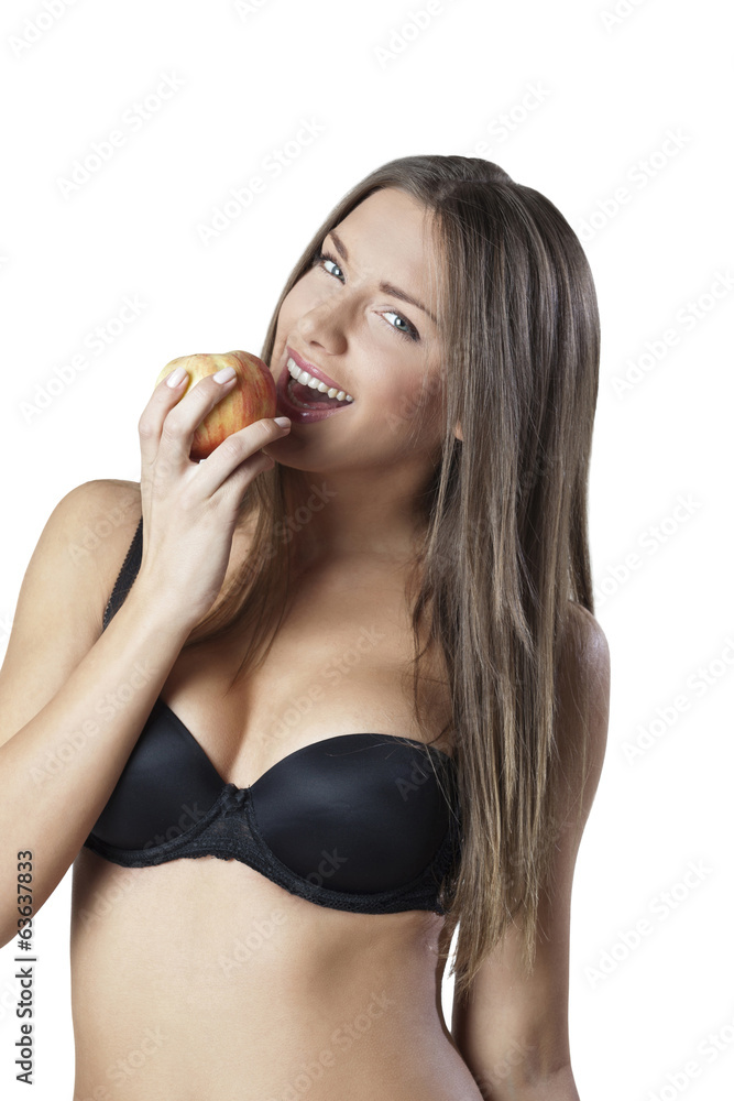 Attractive woman, wearing bra, eating an apple isolated on white Attractive woman, wearing bra, eating an apple isolated on white