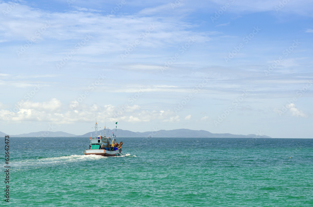 Wooden fishing boat out to sea Wooden fishing boat out to sea