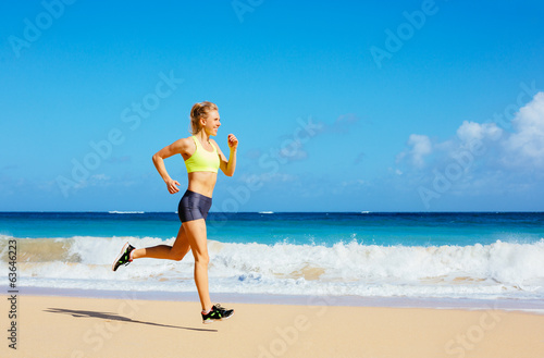 Athletic Young Woman Running on the Beach