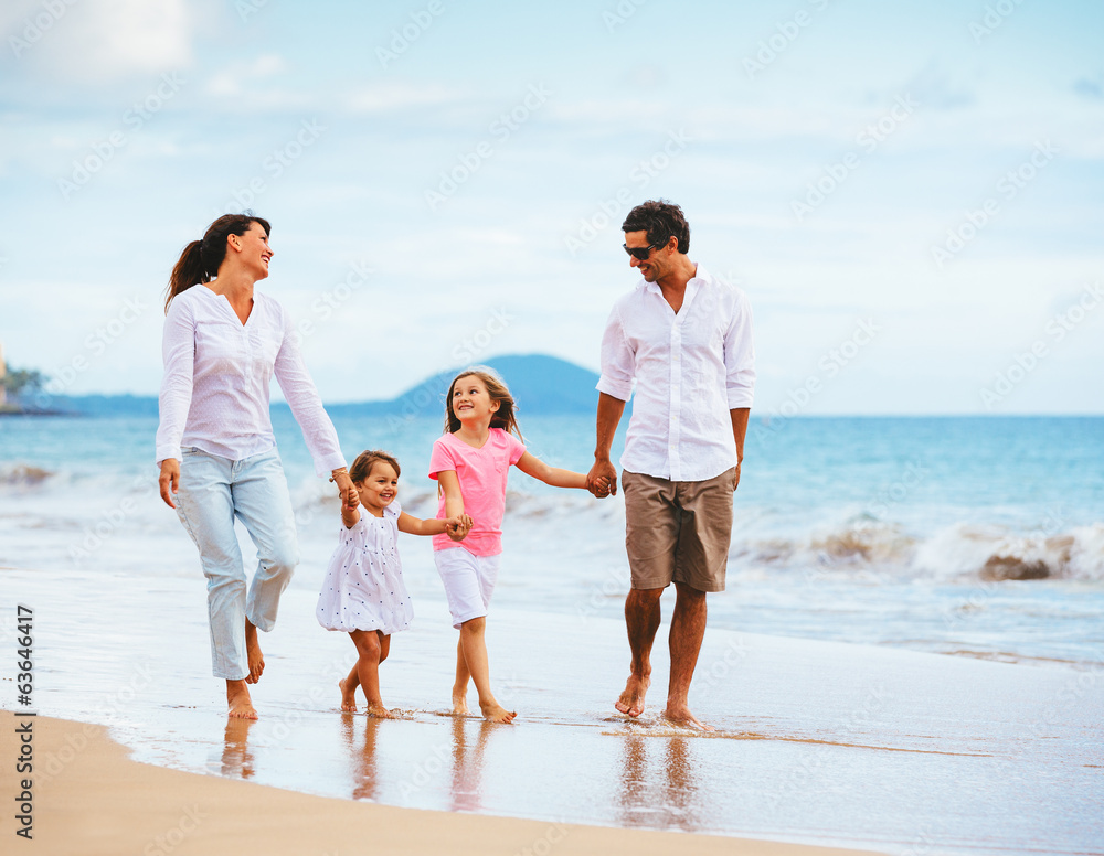 Happy young family walking on the beach Happy young family walking on the beach
