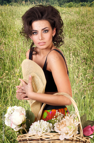 beautiful woman with flowers in the field photo