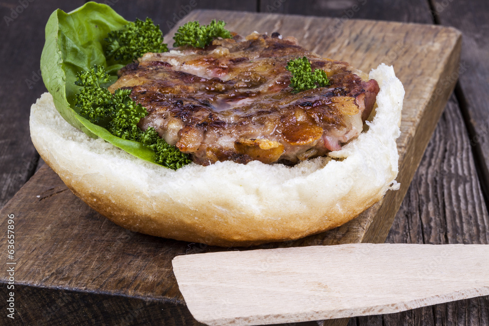 hamburger on a bun with lettuce hamburger on a bun with lettuce