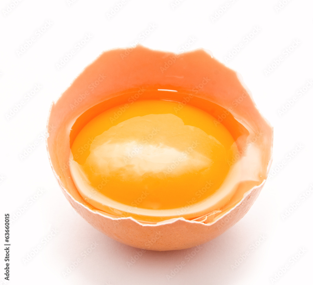 Broken chicken egg and yolk isolated on a white