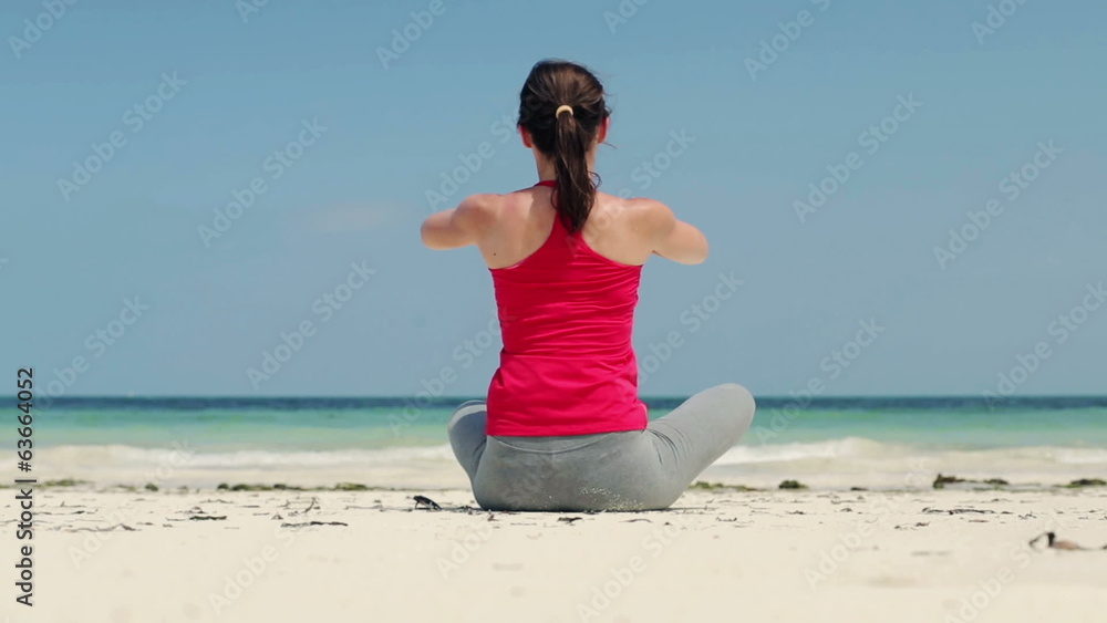Young beautiful woman meditating on the beach Young beautiful woman meditating on the beach