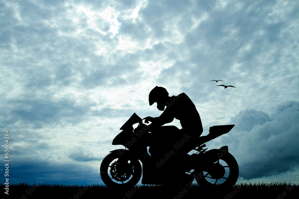 Fototapeta premium motorcyclist at sunset