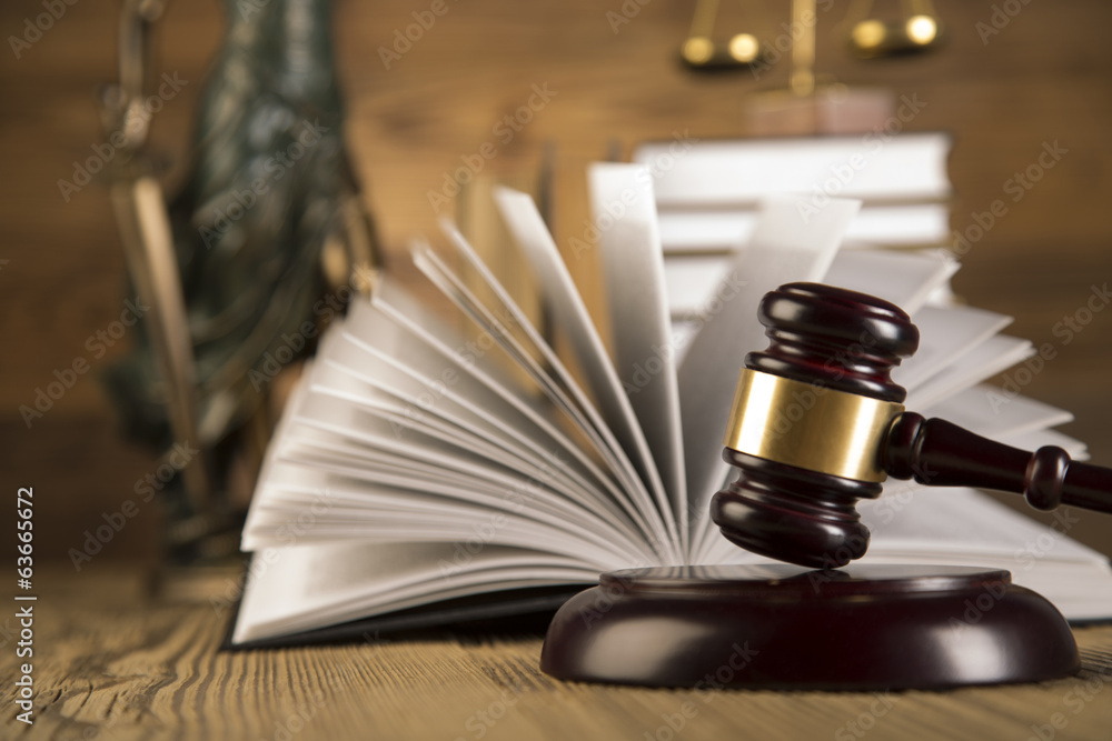 Lady of justice, wooden & gold gavel and books on wooden table Lady of justice, wooden & gold gavel and books on wooden table