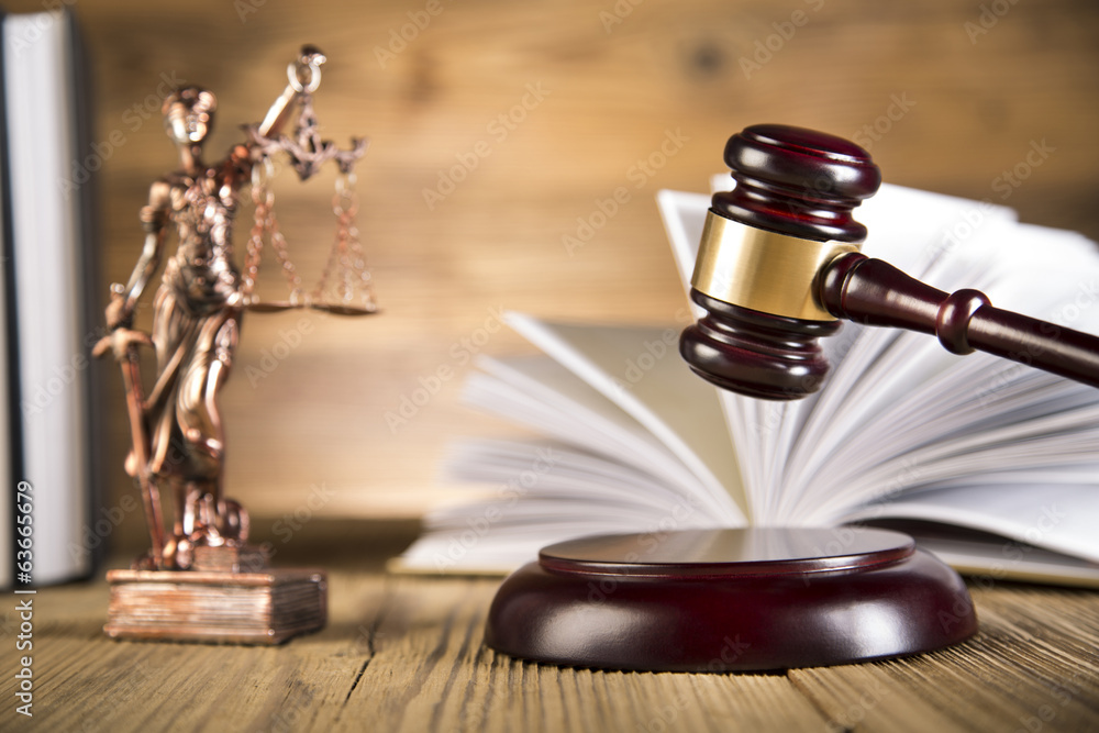 Lady of justice, wooden & gold gavel and books on wooden table Lady of justice, wooden & gold gavel and books on wooden table