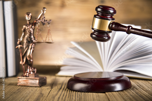 Lady of justice, wooden & gold gavel and books on wooden table