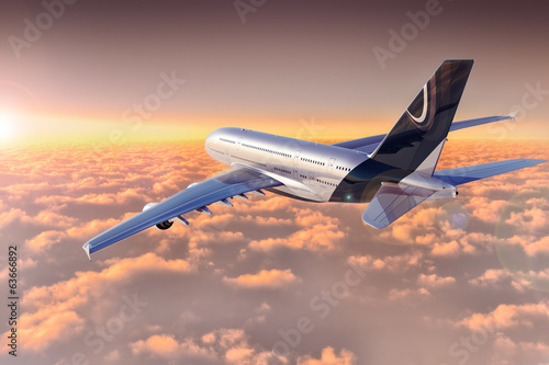 Jet flying over cloudscape at sunset