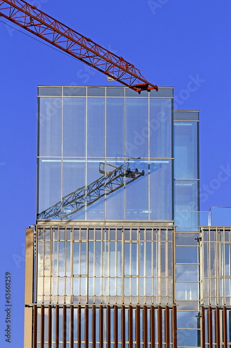 crane with mirror glass skyscraper photo