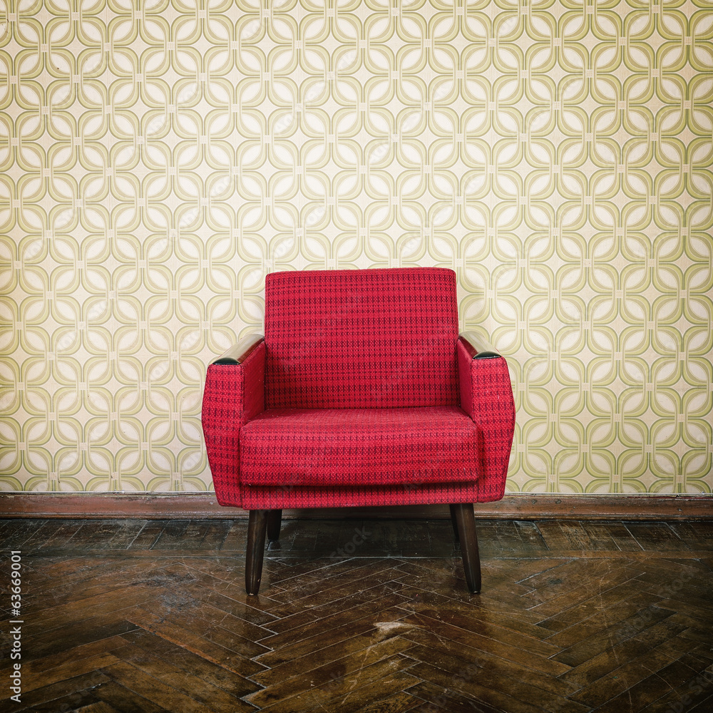 Vintage room with old fashioned red armchair, wallpaper and weat Stock
