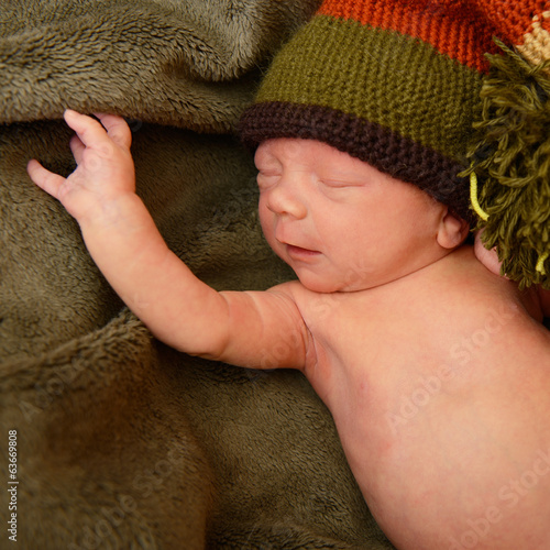 newborn baby, cute sleeping infant in green soft plaid