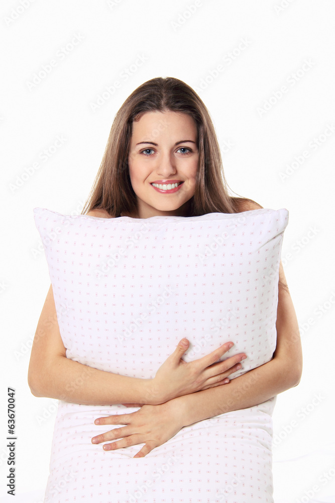 Beautiful girl smiles and embraces her pillow