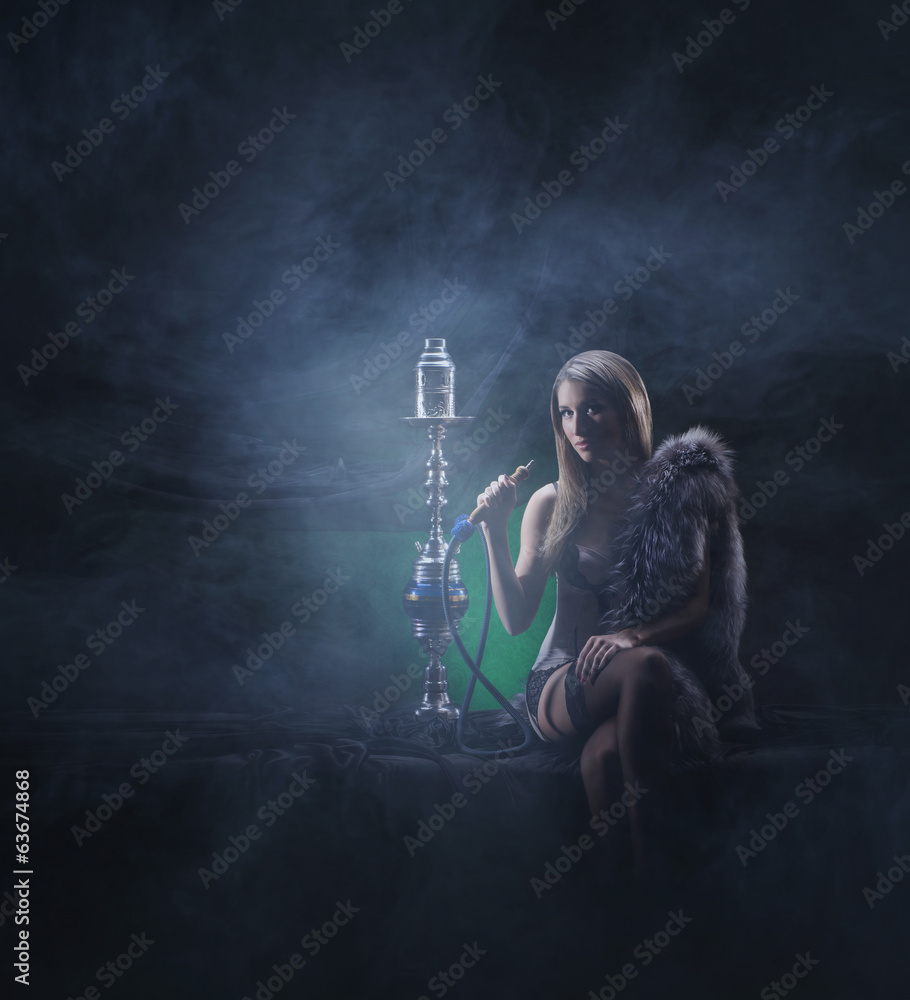 A sexy woman in luxury underwear smoking the hookah A sexy woman in luxury underwear smoking the hookah