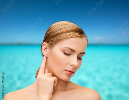 calm woman touching her ear