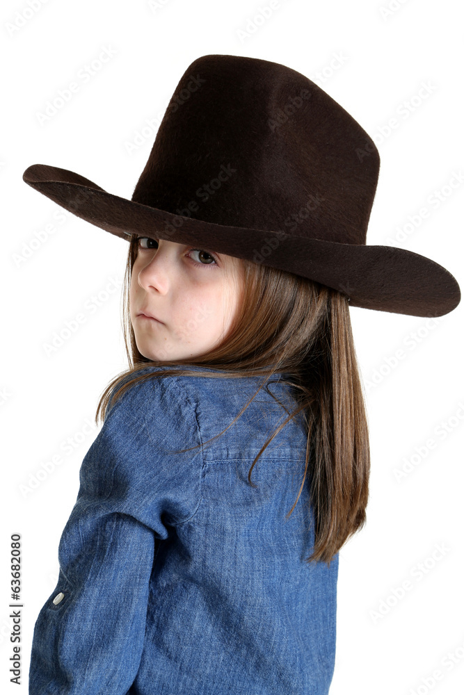 young cowgirl looking over her shoulder with a tough look young cowgirl looking over her shoulder with a tough look