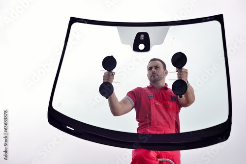 mechanic holding windshield