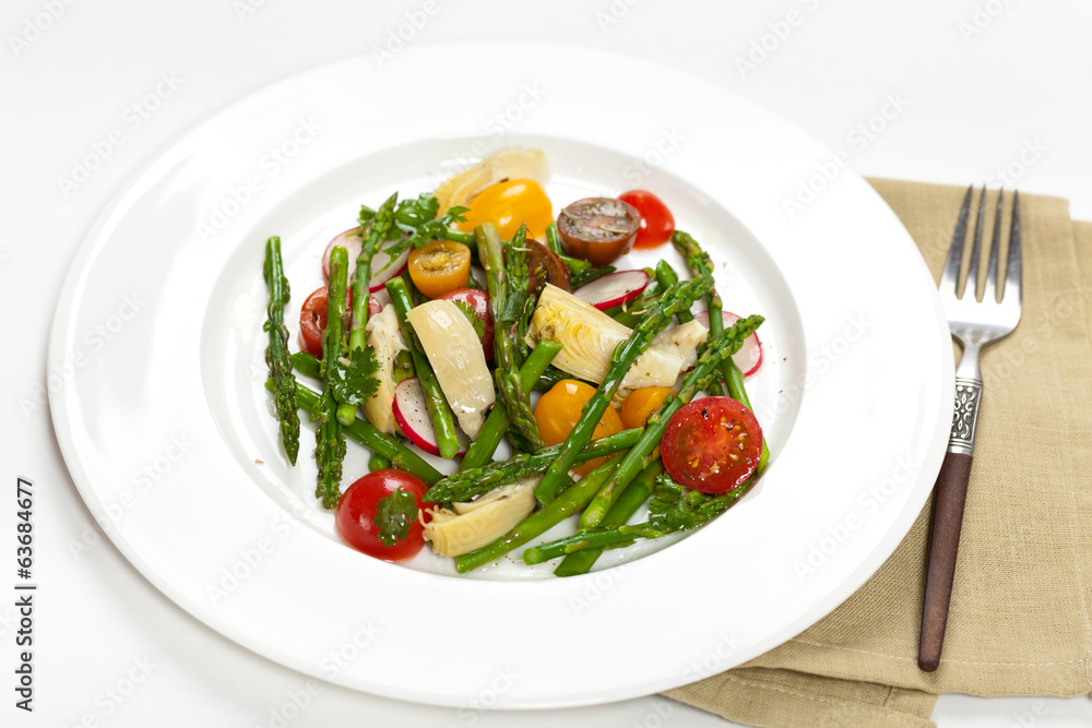 Delicious Fresh salad with asparagus, artichoke and tomatos