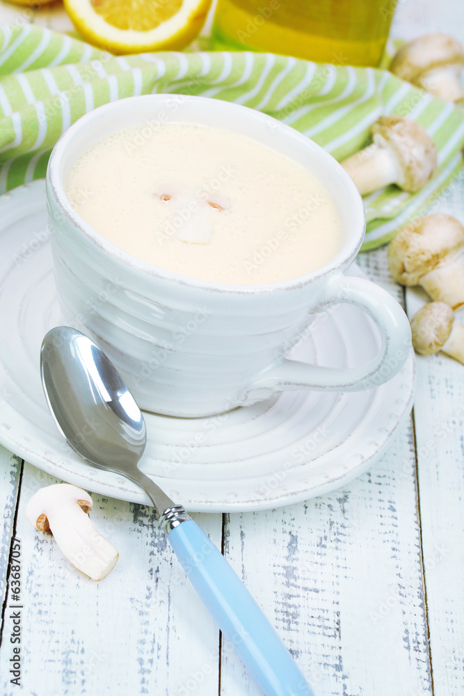 Delicate mushroom sauce in cup on wooden table close-up Delicate mushroom sauce in cup on wooden table close-up