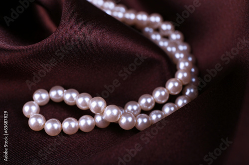 Beautiful pearls on brown silk cloth