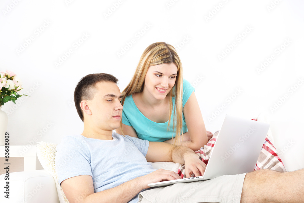 Loving couple sitting with laptop Loving couple sitting with laptop