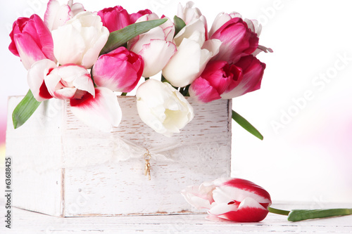 Fototapeta Naklejka Na Ścianę i Meble -  Beautiful tulips  in wooden box, on light background