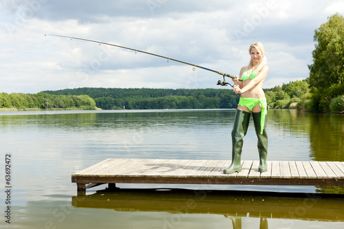 fishing woman standing on pier