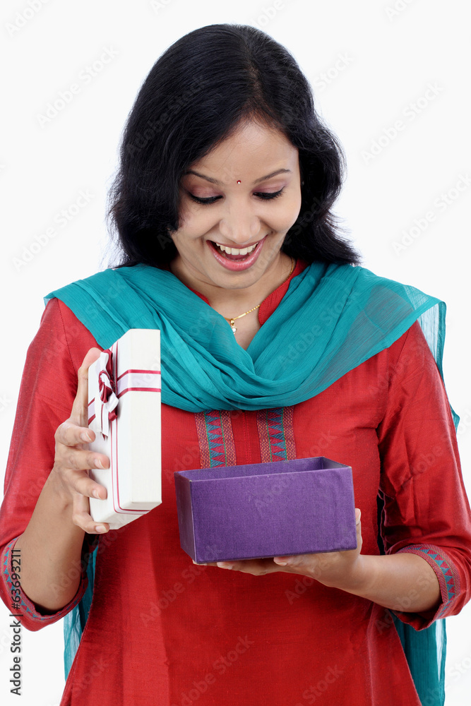 Surprised young woman with gift box Surprised young woman with gift box