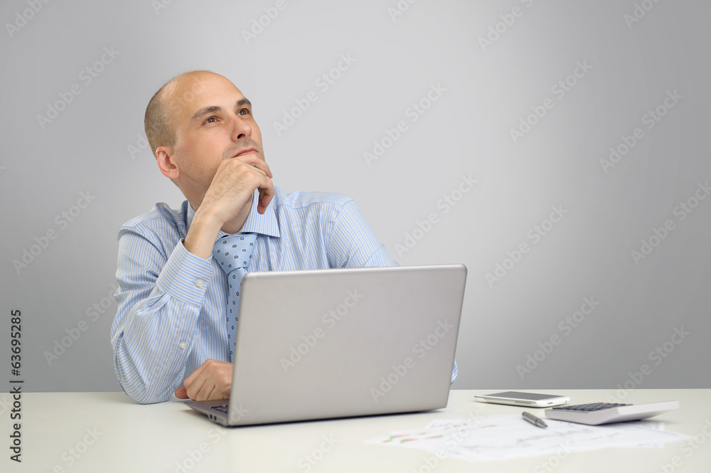 Thoughtful business man working on a laptop Thoughtful business man working on a laptop
