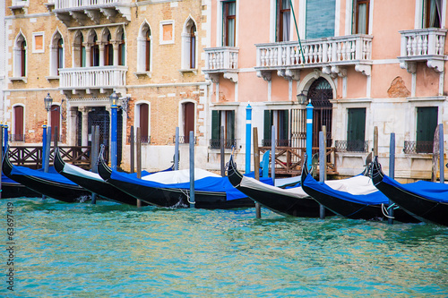 Black and Blue Gondolas Along Venice Canal