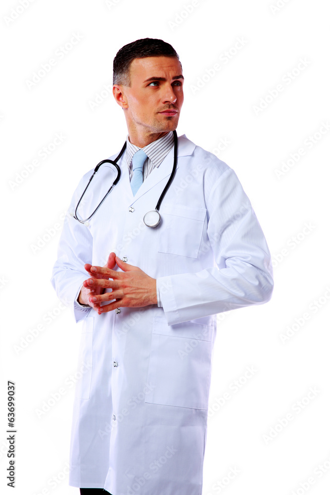 Pensive male doctor standing over white background Pensive male doctor standing over white background